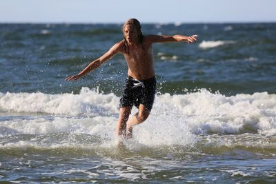 Woman jumping in sea