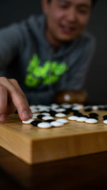 Man playing go game on table