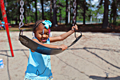 Portrait of young girl playing at park