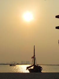 Boat on sea against sky during sunset