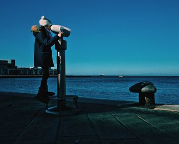 Man standing by sea against clear sky