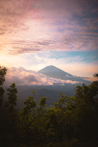 Scenic view of mountains against sky at sunset