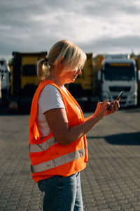 Side view of businesswoman using mobile phone