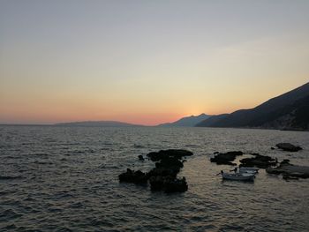 Scenic view of sea against clear sky during sunset