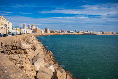 Panoramic view of sea and buildings against sky