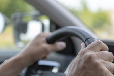 Close-up of man driving car