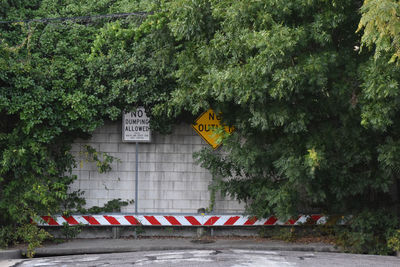 Road sign by trees