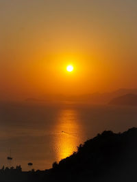 Scenic view of sea against romantic sky at sunset