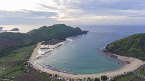 Scenic view of sea and mountains against sky