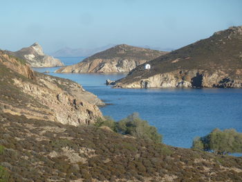 Scenic view of sea and mountains against sky