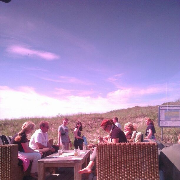 sky, sitting, relaxation, lifestyles, person, leisure activity, chair, cloud - sky, large group of people, men, togetherness, cloud, vacations, outdoors, built structure, day, building exterior, cloudy, table