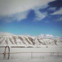 Scenic view of snow covered mountains against sky