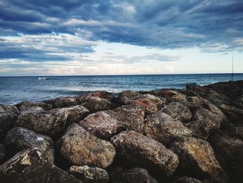 Rocks on beach against sky