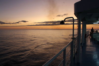 Pier on sea at sunset