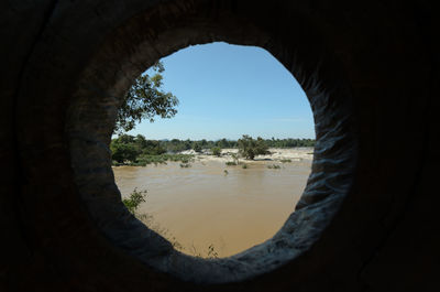 Scenic view of lake seen through hole