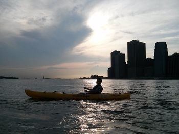 Boats in sea at sunset