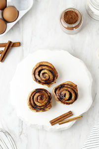 Top view beautiful fresh cinnamon rolls close up on white table. fragrant homemade cakes