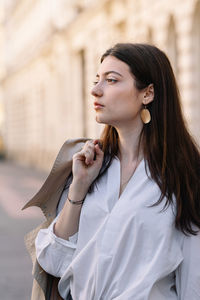 Beautiful young woman looking away outdoors