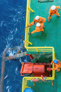 Directly above shot of workers on barge