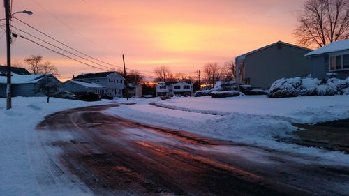 Snow covered landscape at sunset