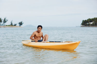 Man kayaking in sea