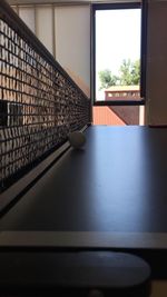 Empty chairs and table by window in house