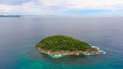 A small island covered in the jungle. caramoan islands, camarines sur, philippines.