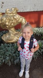 Portrait of smiling girl standing outdoors