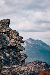 Stack of rocks on mountain against sky