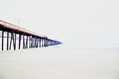 Pier over sea against clear sky