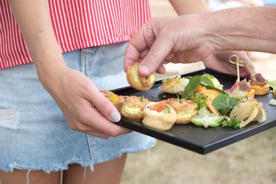 Midsection of people having food