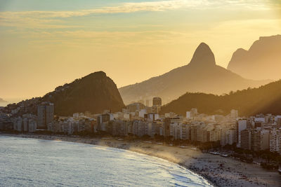 Scenic view of town against sky during sunset