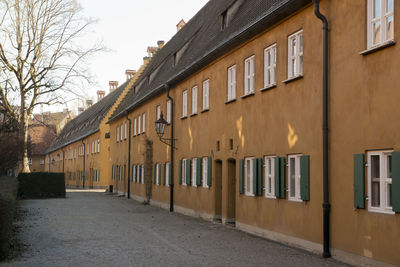 Houses by street against sky