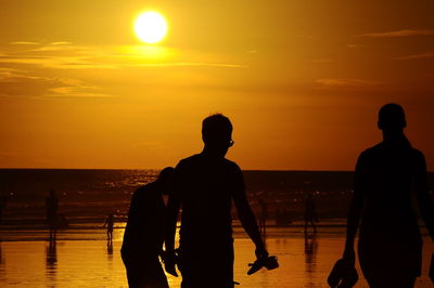 Silhouette man at beach during sunset