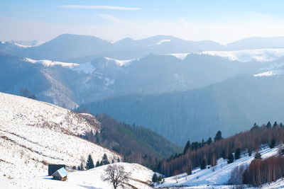 Scenic view of snow covered mountains against sky