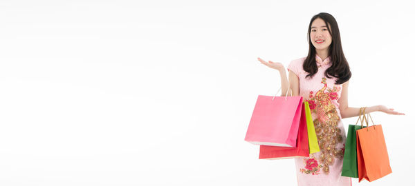 Woman holding umbrella against white background