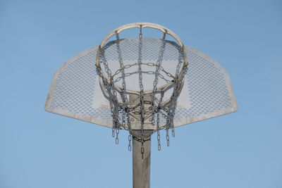 Low angle view of basketball hoop against blue sky