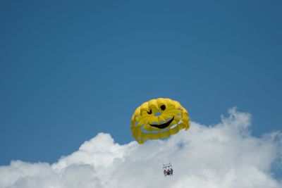 Low angle view of kite flying against blue sky