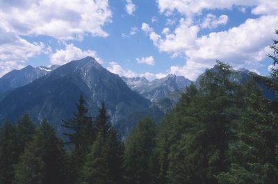 Scenic view of mountains against cloudy sky