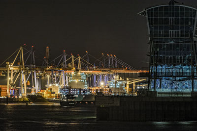 Illuminated commercial dock against clear sky at night