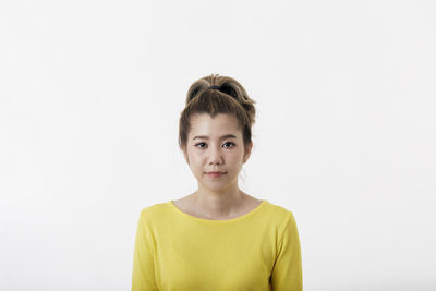 Portrait of woman against white background