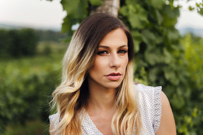 Portrait of beautiful woman against plants