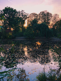 Scenic view of lake against sky at sunset