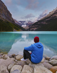 Rear view of man looking at lake