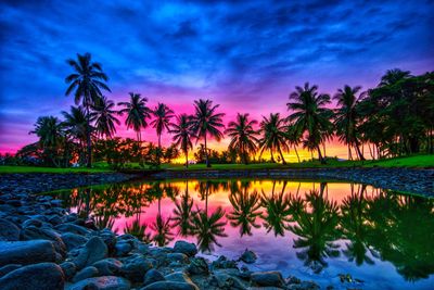 Scenic view of lake against sky at sunset