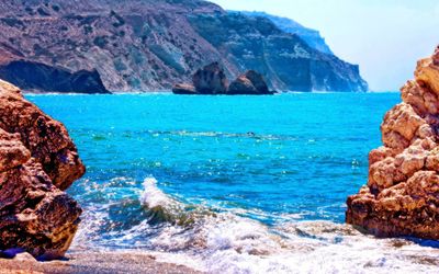 Azure summer waves of warm sea at the rocky coast of cyprus near birthplace of aphrodite