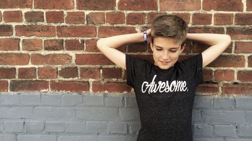 Portrait of young man standing on wall