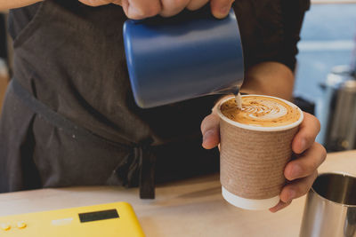 Close-up of person making coffee