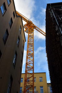 Low angle view of crane against sky