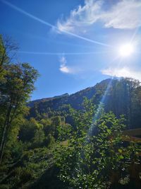 Scenic view of mountains against sky on sunny day